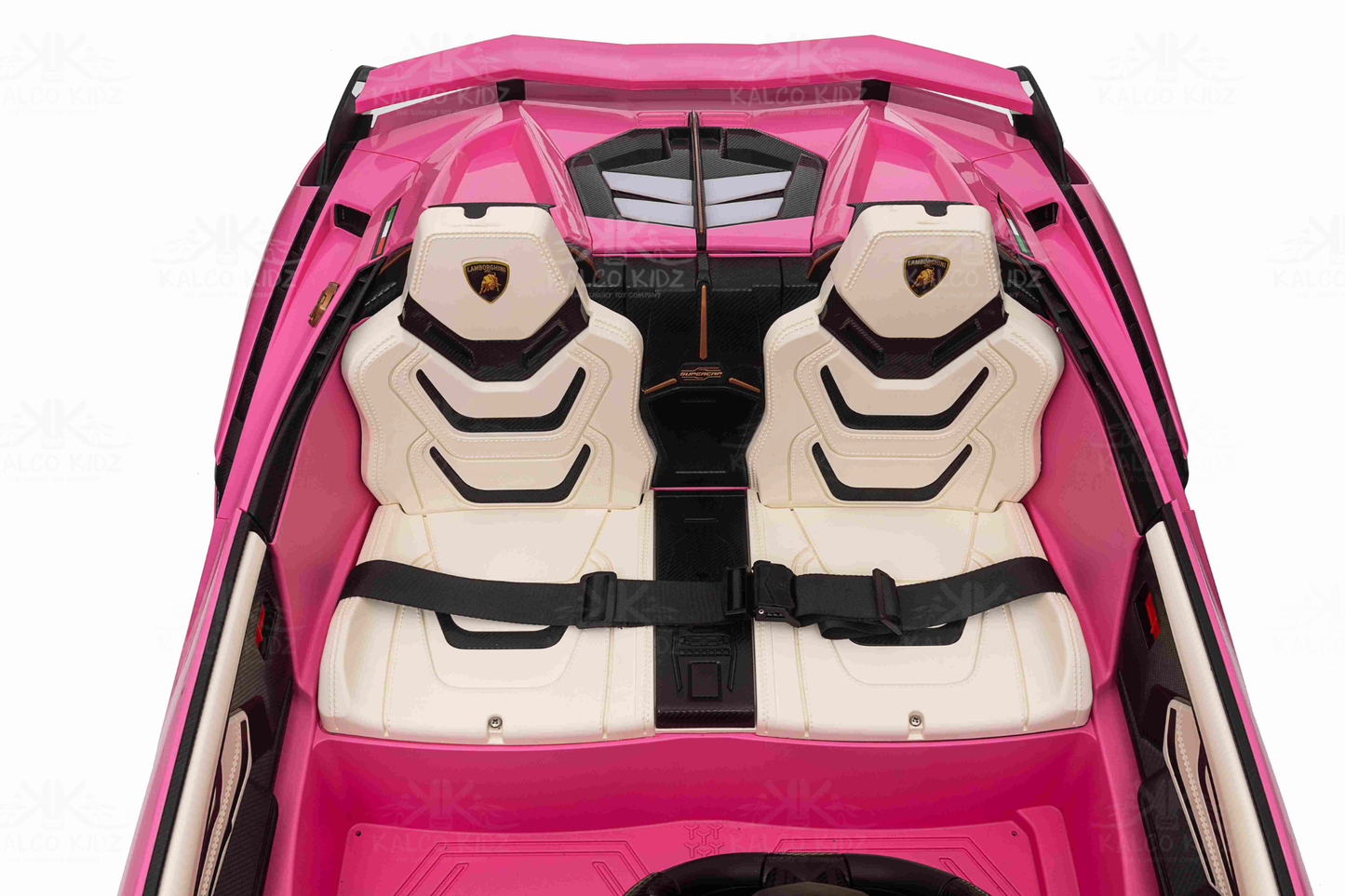 Pink toy car with white seats and black seat belts on a white background